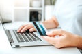 Asian young woman resting and browsing internet with Laptop holding credit card online shopping concept Royalty Free Stock Photo