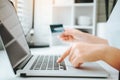 Asian young woman resting and browsing internet with Laptop holding credit card online shopping concept Royalty Free Stock Photo