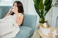 Asian young woman she sick blowing nose sneezing in tissue at home Royalty Free Stock Photo