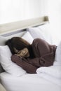 Asian young woman is sick and sleep in the bedroom. A girl hangover from a party last night and she is having a nightmare Royalty Free Stock Photo