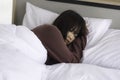 Asian young woman is sick and sleep in the bedroom. A girl hangover from a party last night and she is having a nightmare Royalty Free Stock Photo