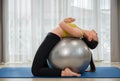 Asian young woman in sportswear doing abs exercises on a fitness ball for healthcare slim fit and body weight control at home Royalty Free Stock Photo