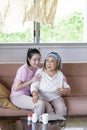 Asian young woman take care and support with warn hug, that make feel good and smile older mother in living room. family concept Royalty Free Stock Photo