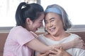 Asian woman take care and warn hug mother, she is very happy and smile in living room Royalty Free Stock Photo