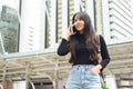 Asian young woman talking telephone in city. Royalty Free Stock Photo