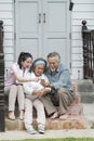 Young woman teach `how to used mobile for online shoping` older father and mother in outdoor terrace house. -lovely family c Royalty Free Stock Photo