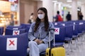 Asian young woman traveller wearing face maks at airport Due Covid-19 flu virus pandemic