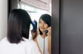 Asian woman using hair irons with straightening Royalty Free Stock Photo