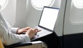 Asian young woman using laptop blank screen sitting near windows at first class on airplane during flight, Traveling and