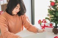 Asian young woman using laptop computer and holding credit card for christmas online shopping Royalty Free Stock Photo