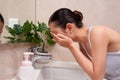 Asian young woman washing her face on the sink Royalty Free Stock Photo