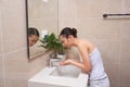 Asian young woman washing her face on the sink Royalty Free Stock Photo