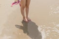 Asian young woman wearing a pare on the beach. standing barefoot