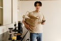 Asian young woman wearing t-shirt using mobile phone on kitchen Royalty Free Stock Photo