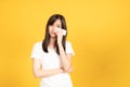 Asian young woman wearing white t-shirt standing and holding a tissue paper using her face wiping tears Royalty Free Stock Photo