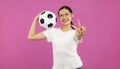 Asian Young woman in white t-shirt looking at camera and holding a soccer ball, football concept Royalty Free Stock Photo
