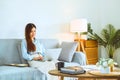 Asian young woman working from home using computer and drinking coffee in her room document finance and conference online meeting Royalty Free Stock Photo