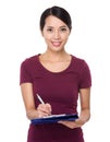 Asian young woman write on clipboard Royalty Free Stock Photo