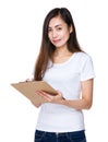 Asian young woman write on file board Royalty Free Stock Photo