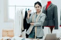 Asian young women fashion designer  working on her designer in the showroom,  Lifestyle Stylish tailor taking measurements on mann Royalty Free Stock Photo