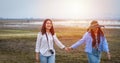 Asian Young women are having fun and laughing and hugging on the green field in the evening Royalty Free Stock Photo