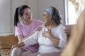 Asian young woman take care and support with warn  hug, that make feel good and smile older mother in living room. family concept Royalty Free Stock Photo