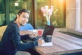 Asian younger freelance man working at home office with compute