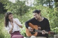 asian younger man and woman playing guitar with happiness emotion Royalty Free Stock Photo
