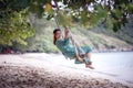 Asian younger woman relaxing on swing  at beach Royalty Free Stock Photo