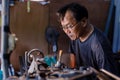 Asians Craftsman being machined steel in a factory