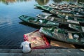 Asiatic Woman handwashes laundry in the amazing harbor with wooden boats moored. A unique scene of typical Vietnamese life