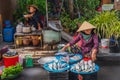 Asiatic woman takeher lunch in an asiatic market.