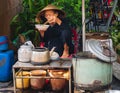 Asiatic woman takeher lunch in an asiatic market.