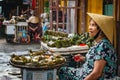 Asiatic womans work in the market. Vietnamese woman vendor