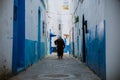 Asilah, Morocco - 19 September 2019: A narrow street in with blue & white & red style Royalty Free Stock Photo