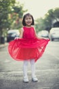 Asina children girl wearing red skirt dress toothy smiling face happiness emotion Royalty Free Stock Photo