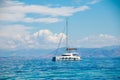 Asingle catamaran in the open sea.Sailboat in the Mediterranean Sea.catamaran sailing boat near coast.catamaran sail