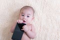 Asis Lying baby child is with mobile phone Royalty Free Stock Photo