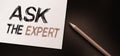 Ask the Expert Text written on notebook page, red pencil on the right. Motivational Concept image Royalty Free Stock Photo