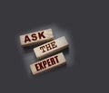 Ask the Expert words on wooden blocks. Consulting a professional, master or consultant for a solution and advice Royalty Free Stock Photo