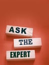 Ask the Expert words on wooden blocks. Consulting a professional, master or consultant for a solution and advice Royalty Free Stock Photo