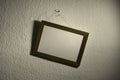 Askew picture frame on wall Royalty Free Stock Photo