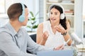 Asking the important questions thats on everyones mind. a young man and woman doing a broadcast in an office.