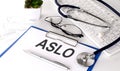 ASLO text on white paper on white background. stethoscope ,glasses and keyboard