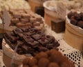 Asorted chocolate truffles and pralines. Chocolate and coconut candies on the counter in the confectionery store