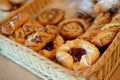 Assorted pastry in basket at breakfast serving. Selective focus