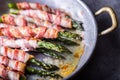 Asparagus. Asparagus and roll bacon. Grilled asparagus with rolled bacon and fried egg. Fried old pan full of rolled bacon with Royalty Free Stock Photo