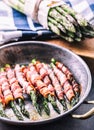 Asparagus. Asparagus and roll bacon. Grilled asparagus with rolled bacon and fried egg. Fried old pan full of rolled bacon with Royalty Free Stock Photo