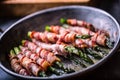 Asparagus. Asparagus and roll bacon. Grilled asparagus with rolled bacon and fried egg. Fried old pan full of rolled bacon with Royalty Free Stock Photo