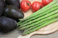 Asparagus,avocados and tomatoes in a wooden background